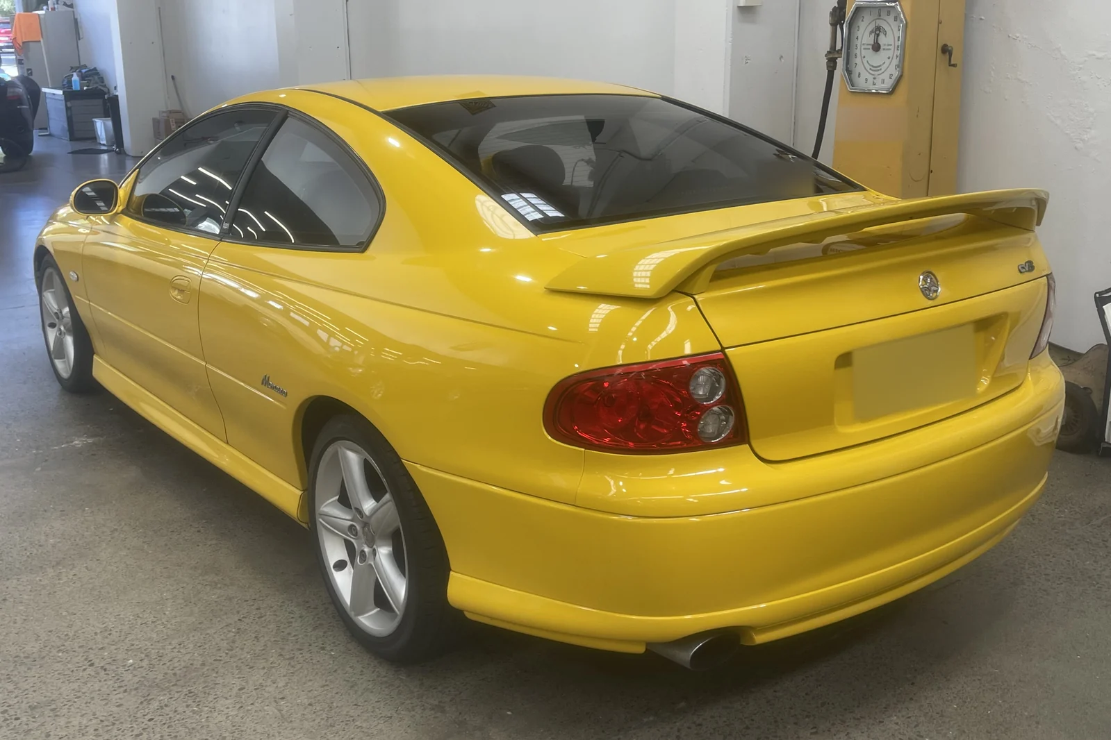 Yellow Holden Monaro photographed from the rear