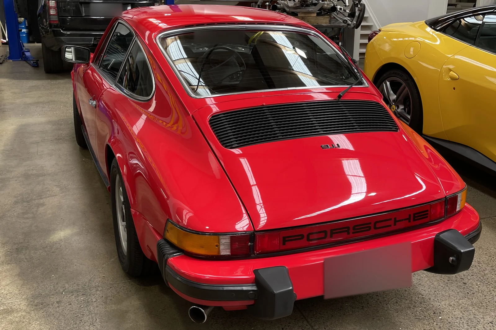 Red Porsche 911 photographed from the rear